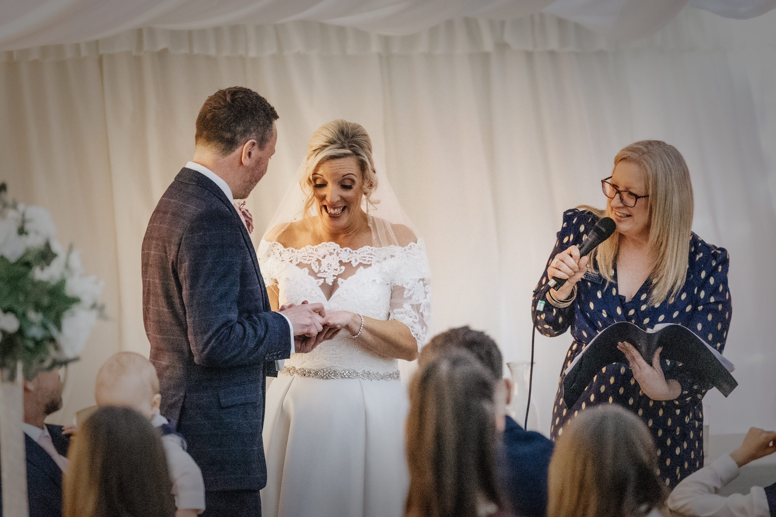 Deb Reed Celebrant Essex Colchester officiating Rachael and Lukes wedding, smiling at their son.